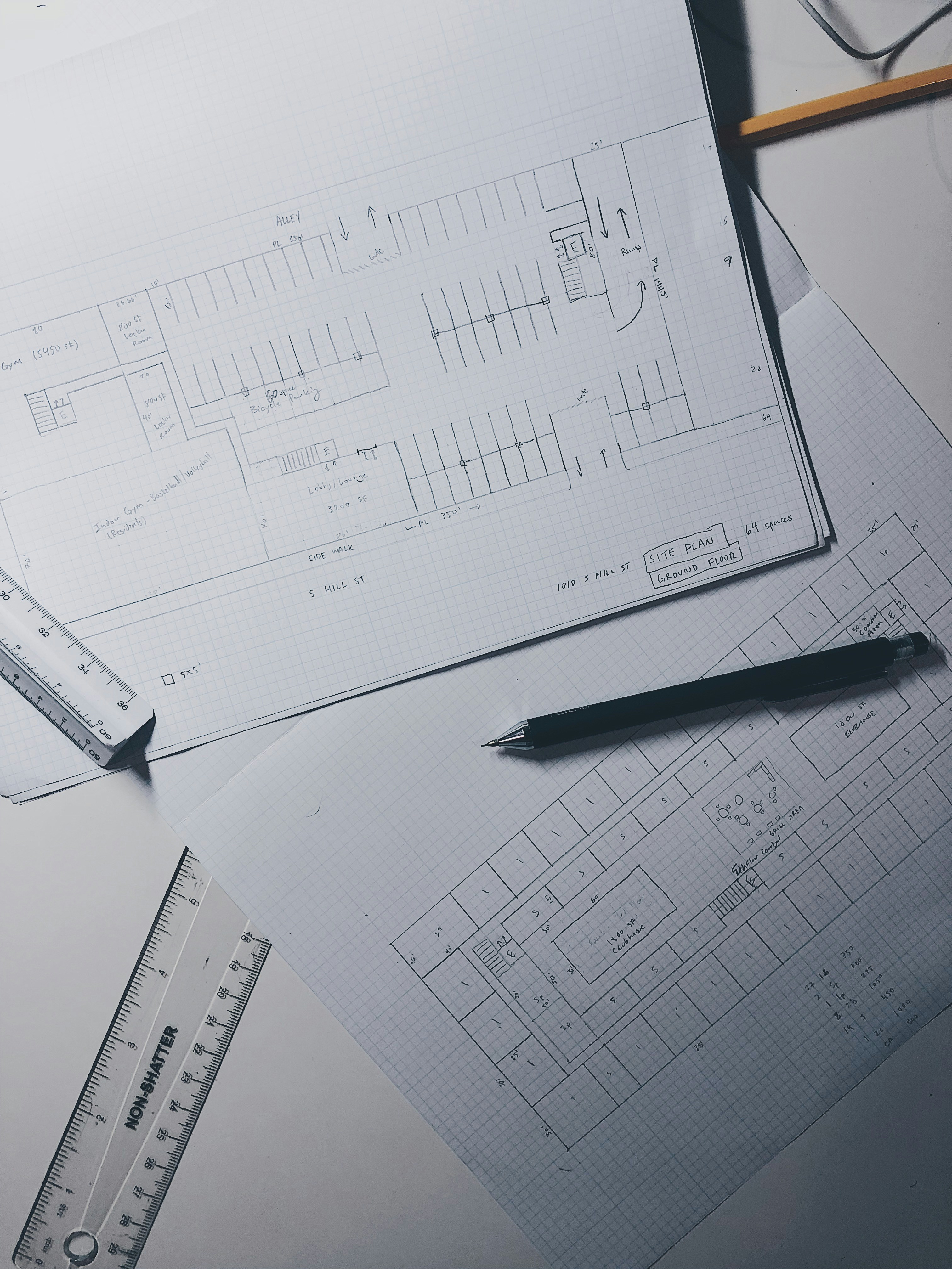 Professional consultation meeting with architectural plans and site analysis documents