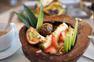 Freshly prepared Balinese fruit platter served beside a calming lotus pond.
