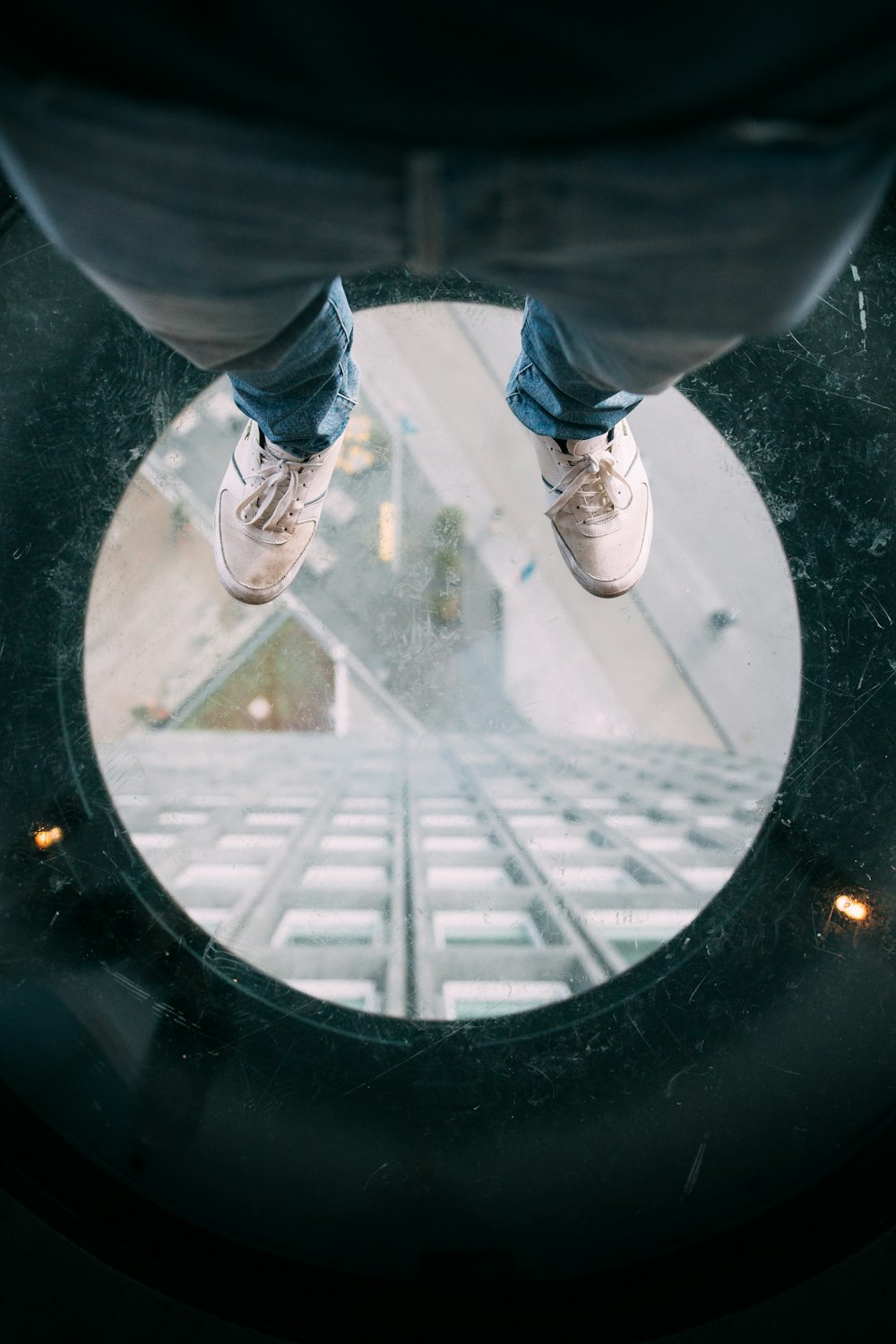 person standing on round clear glass