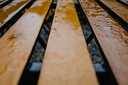 Close-up of a freshly washed wooden deck glistening with moisture.