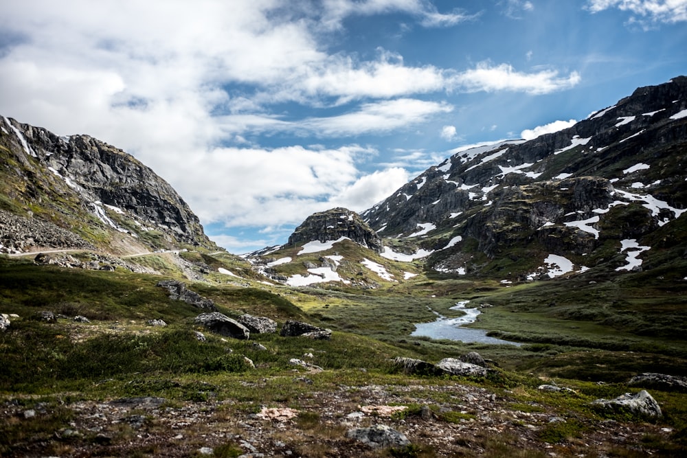 snow covered mountain under blue sky and white clouds