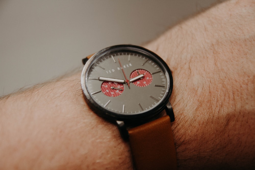 person in black chronograph watch