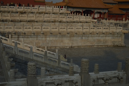 An elegant heritage revival estate featuring stone walls and traditional Indian architectural elements.