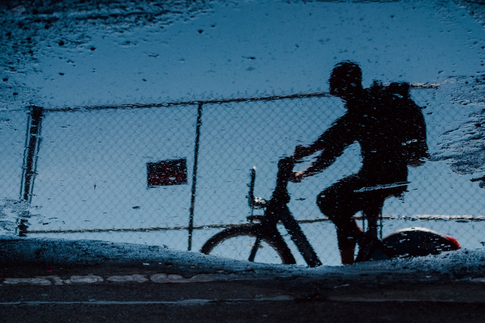 man on bicycle grayscale photo