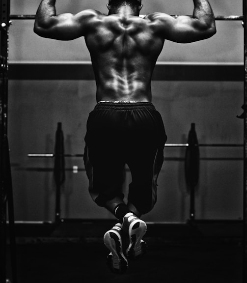 grayscale photo of man working out