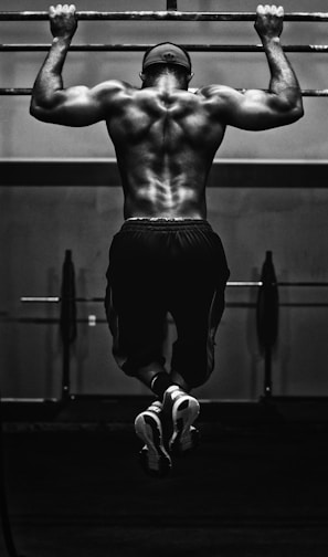 grayscale photo of man working out