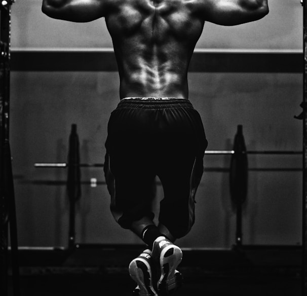 grayscale photo of man working out