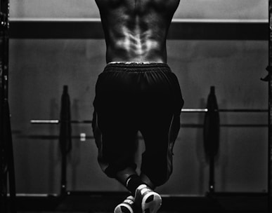 grayscale photo of man working out