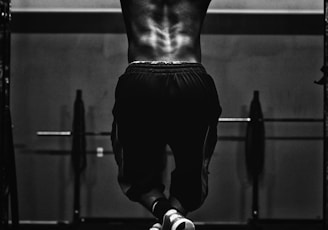 grayscale photo of man working out