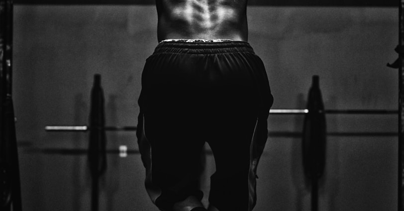 grayscale photo of man working out