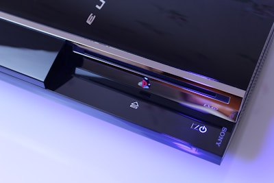 Side view of the PS4 console with visible ports and ventilation.