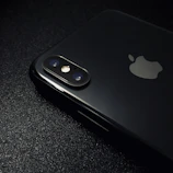 Close-up shot of a sleek iPhone 14 Pro with gold accents on a black background