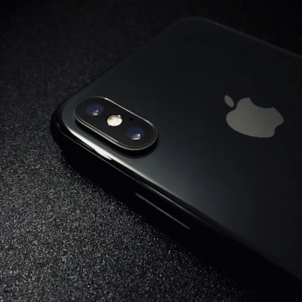 Close-up shot of a sleek iPhone 14 Pro with gold accents on a black background