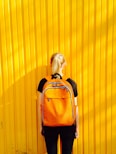 photo of woman facing yellow wall