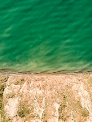 Wide-angle view of a coastal cliff taken by a drone with advanced stabilization.