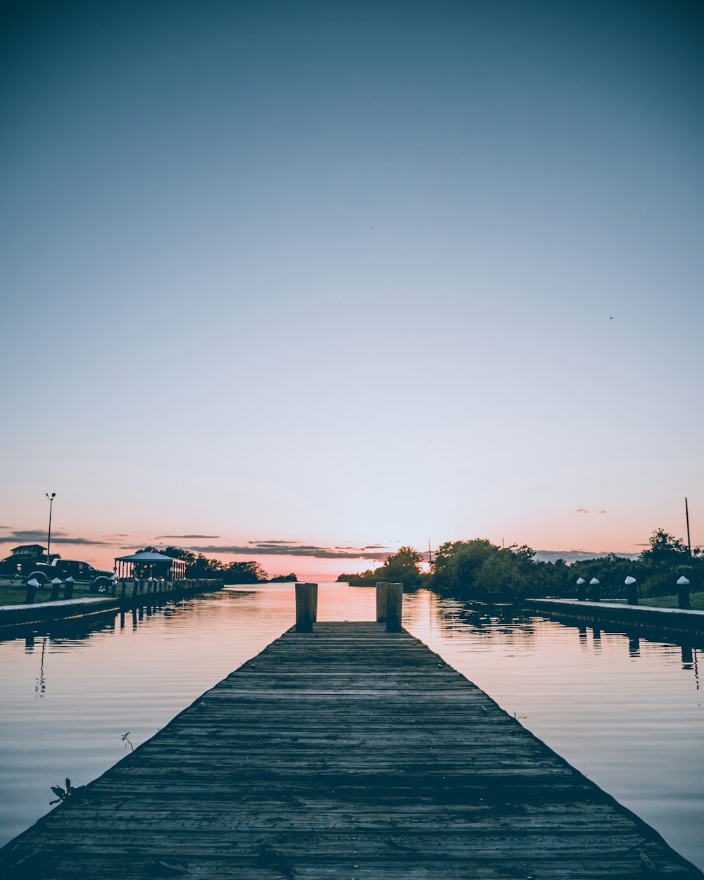 gray wooden dock under blue sky