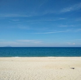 A serene beach with crystal clear waters and soft sand.
