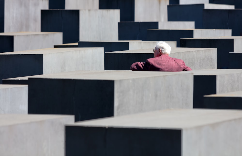 person in front of concrete cube