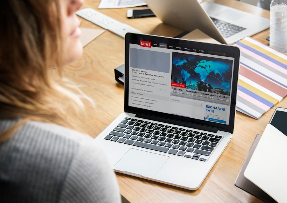 woman in front of laptop on wooden table