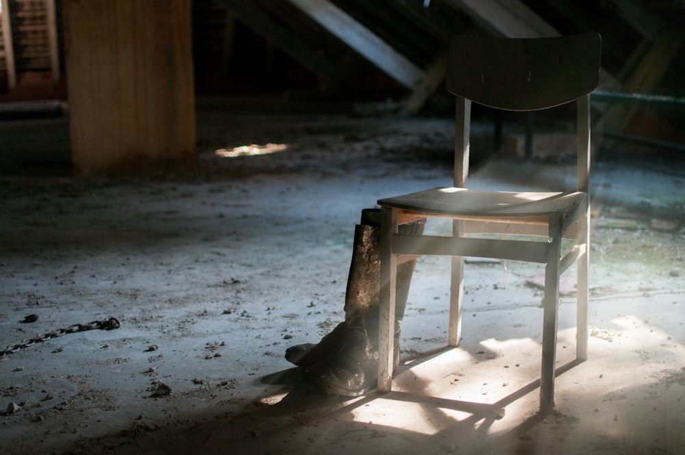 pair of boots beside chair