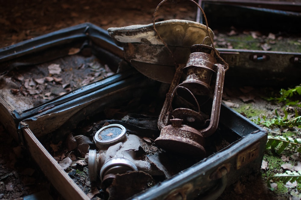 brass-colored oil lantern inside open case