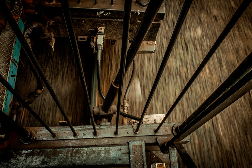 an overhead view of a wooden floor with metal bars