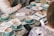 A group of friends discussing ideas around a table with coffee cups.