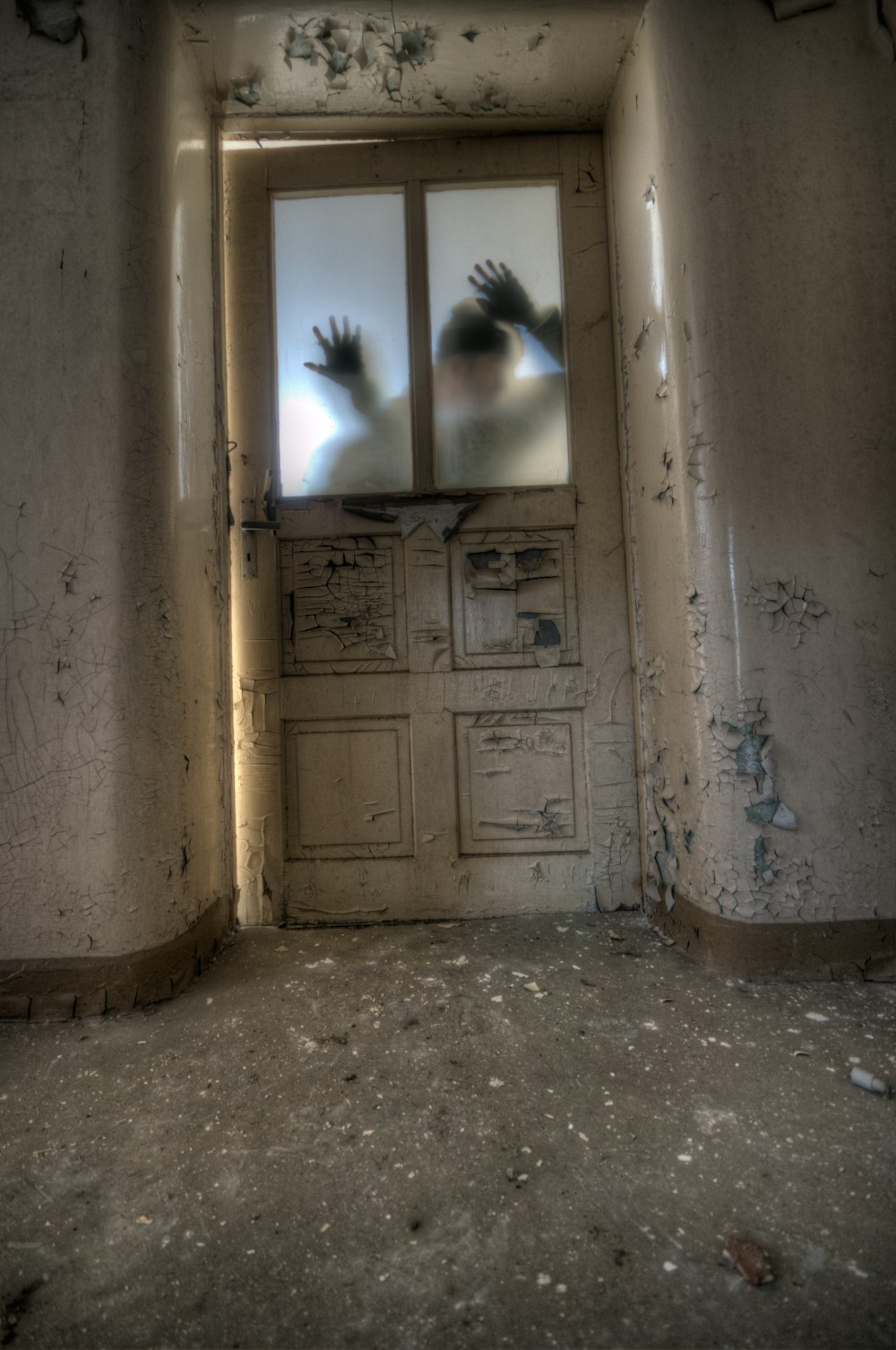 man leaning on frosted glass panel door