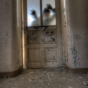 man leaning on frosted glass panel door