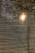 Horizontal blinds partially open with sunlight streaming through, creating a pattern of light and shadow across the blinds.
