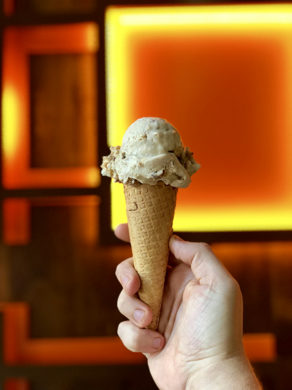 person holding cone with icecream