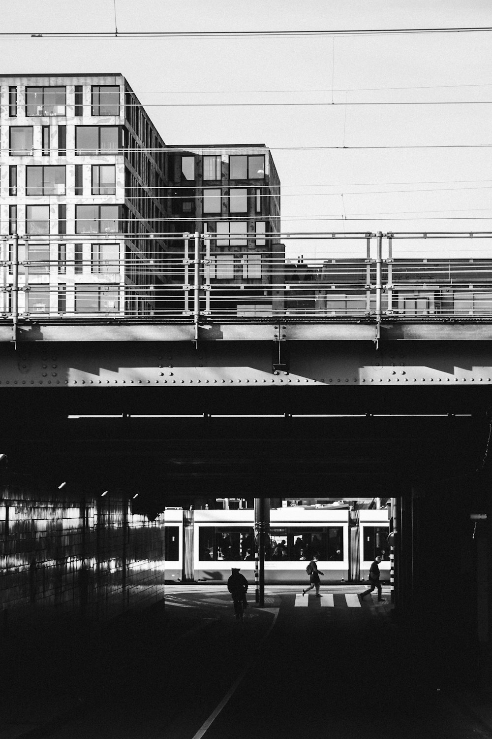 grayscale photograph of train bridge