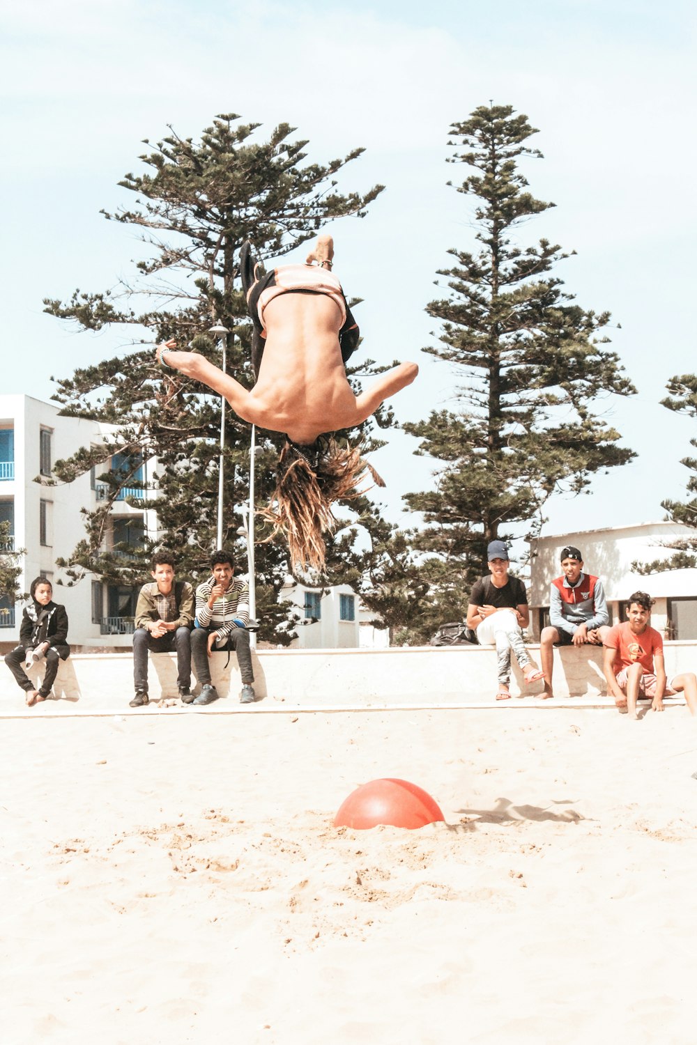 person tumbling on sand during daytime