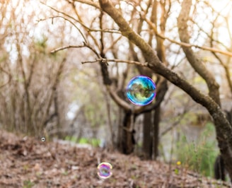 A cheerful pastel-colored spray can of foam soap with playful bubbles floating around.