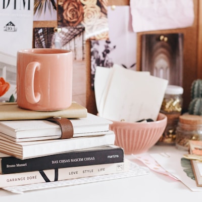 brown ceramic coffee mug on book