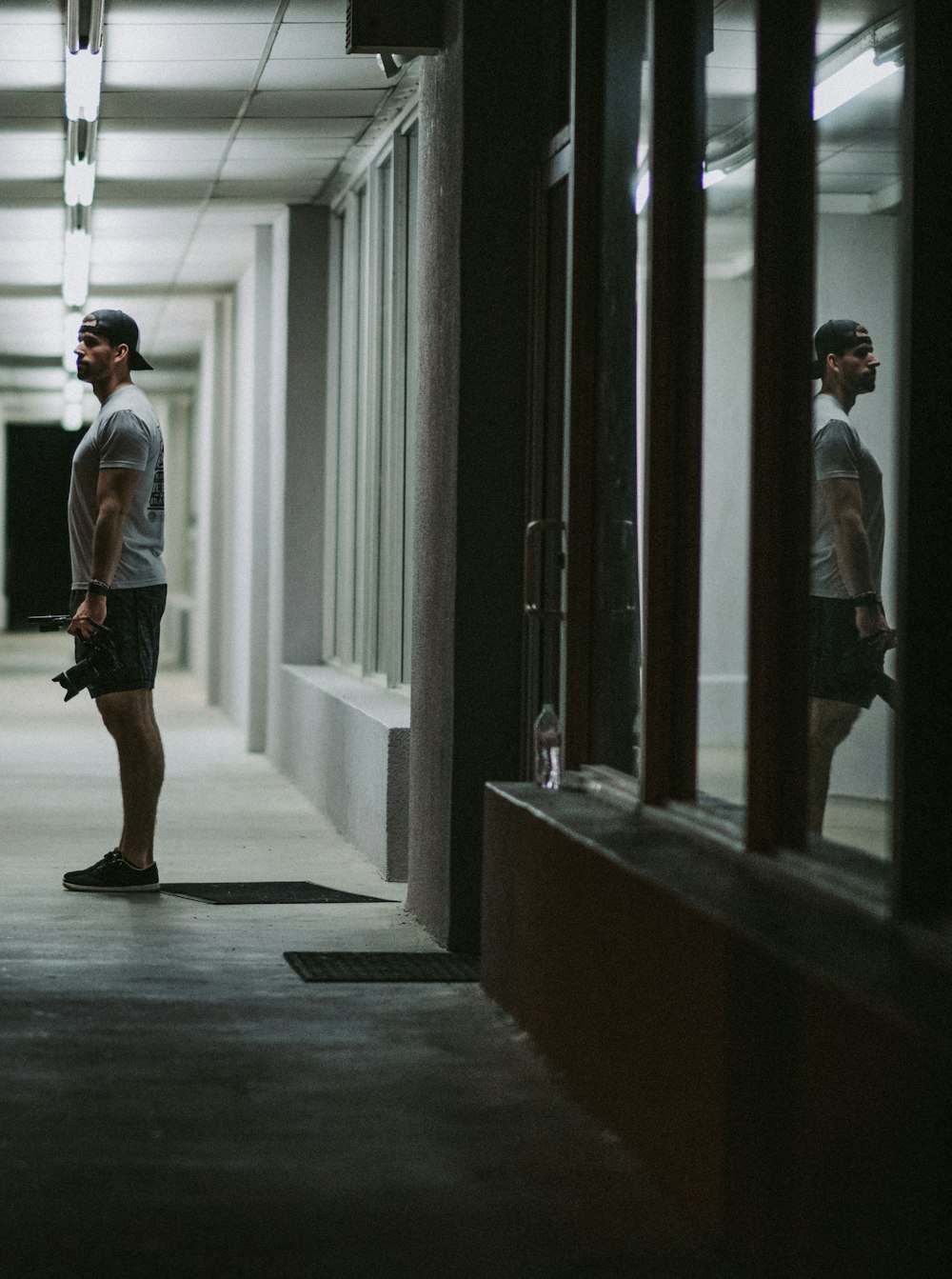 a couple of men standing in a hallway next to each other