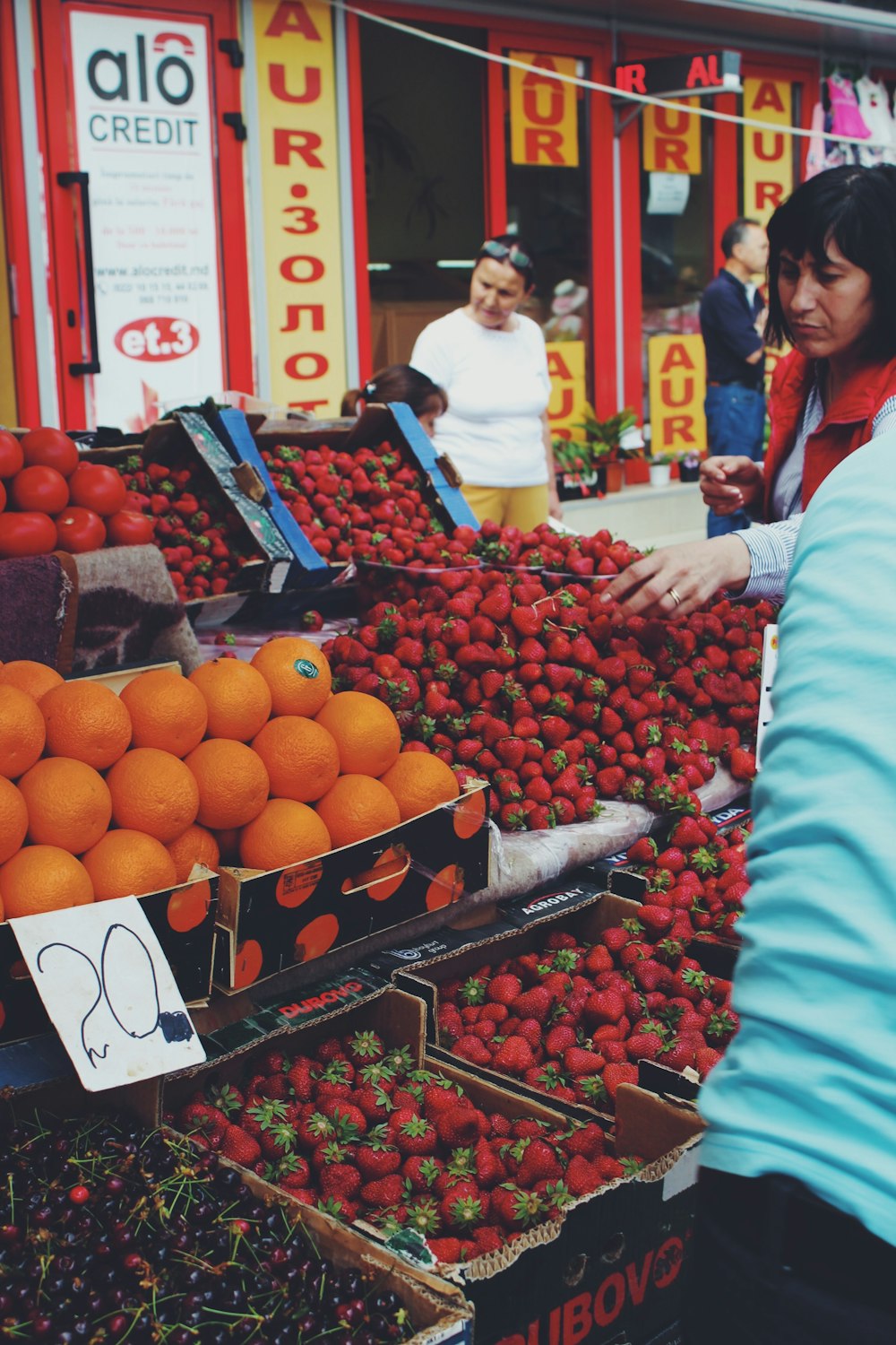 woman buying strawberries at the market