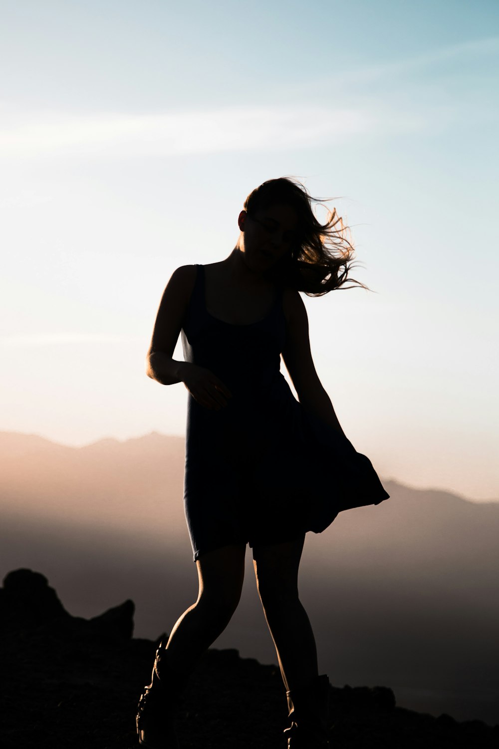 silhouette of woman on hill top view