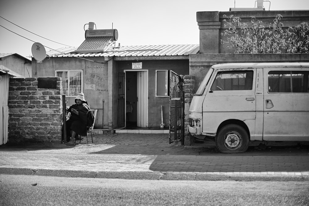 a person sitting in a chair in front of a van