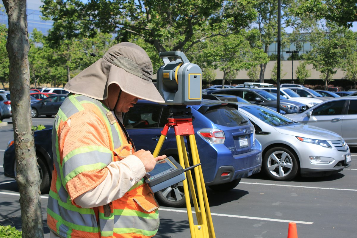 Surveyor recording elevation data with a handheld data collector