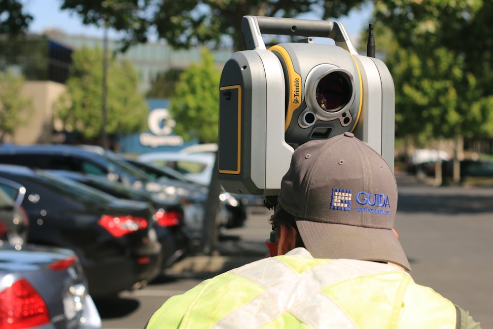 man looking at device on road