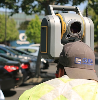 man looking at device on road