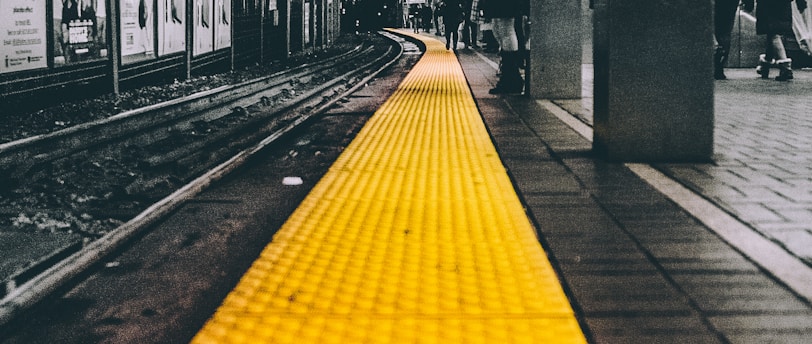 selective color photo of train station