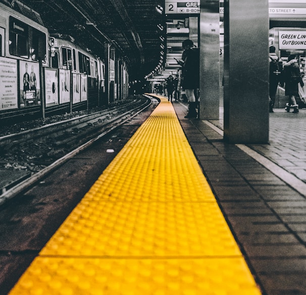 selective color photo of train station