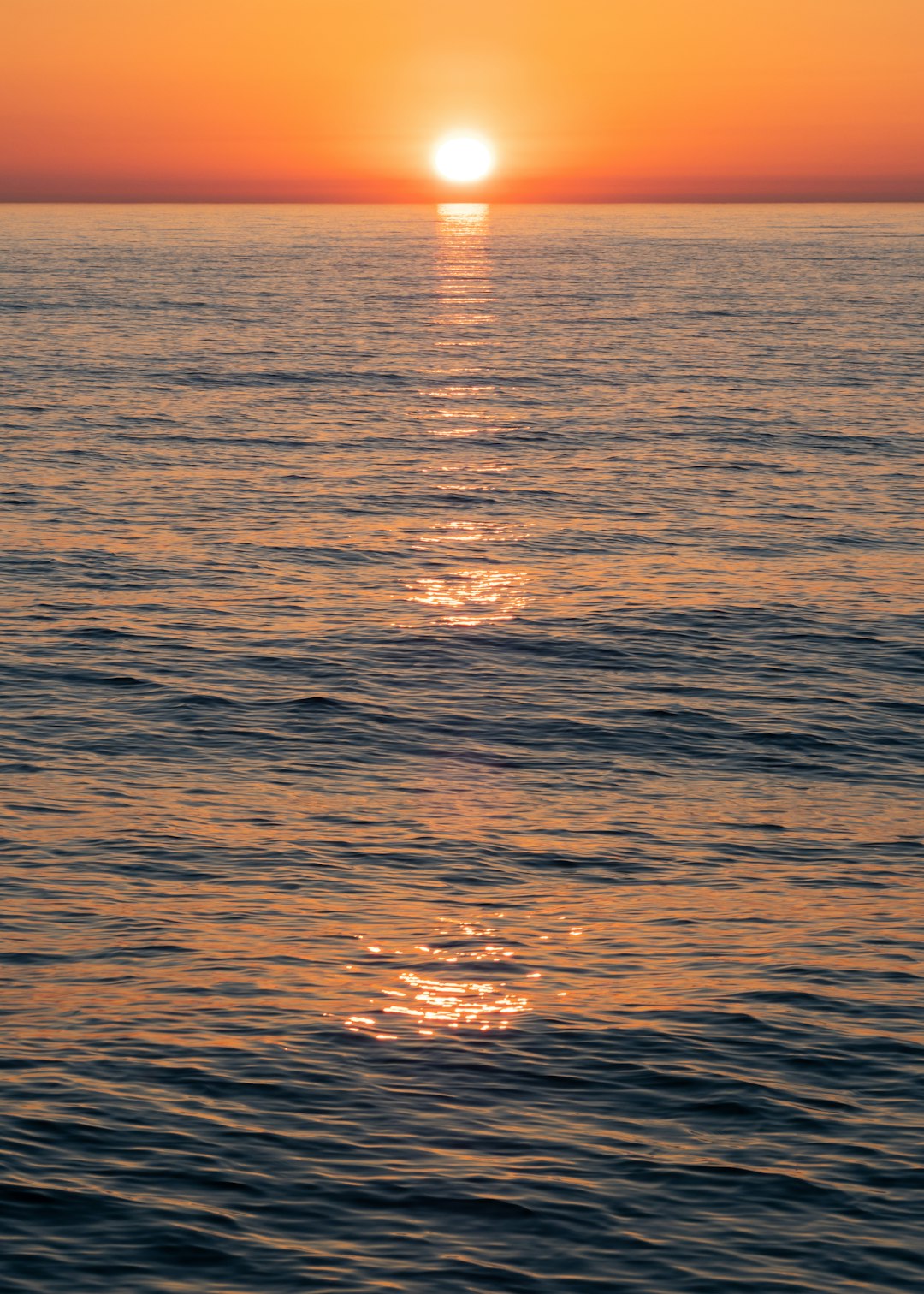 reflection of sun on body of water