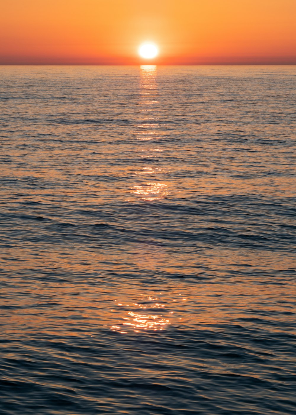 reflection of sun on body of water