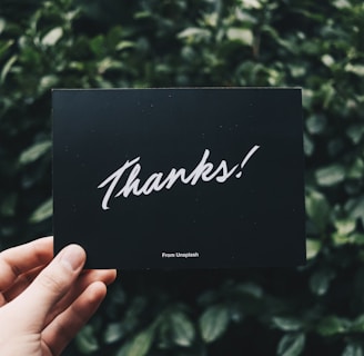 person holding Thanks card