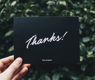 person holding Thanks card