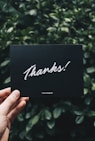 person holding Thanks card