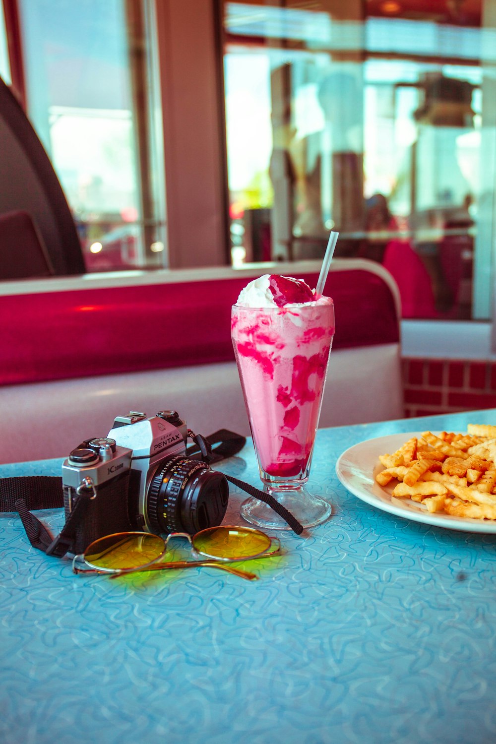 pink plastic cup on blue round plate